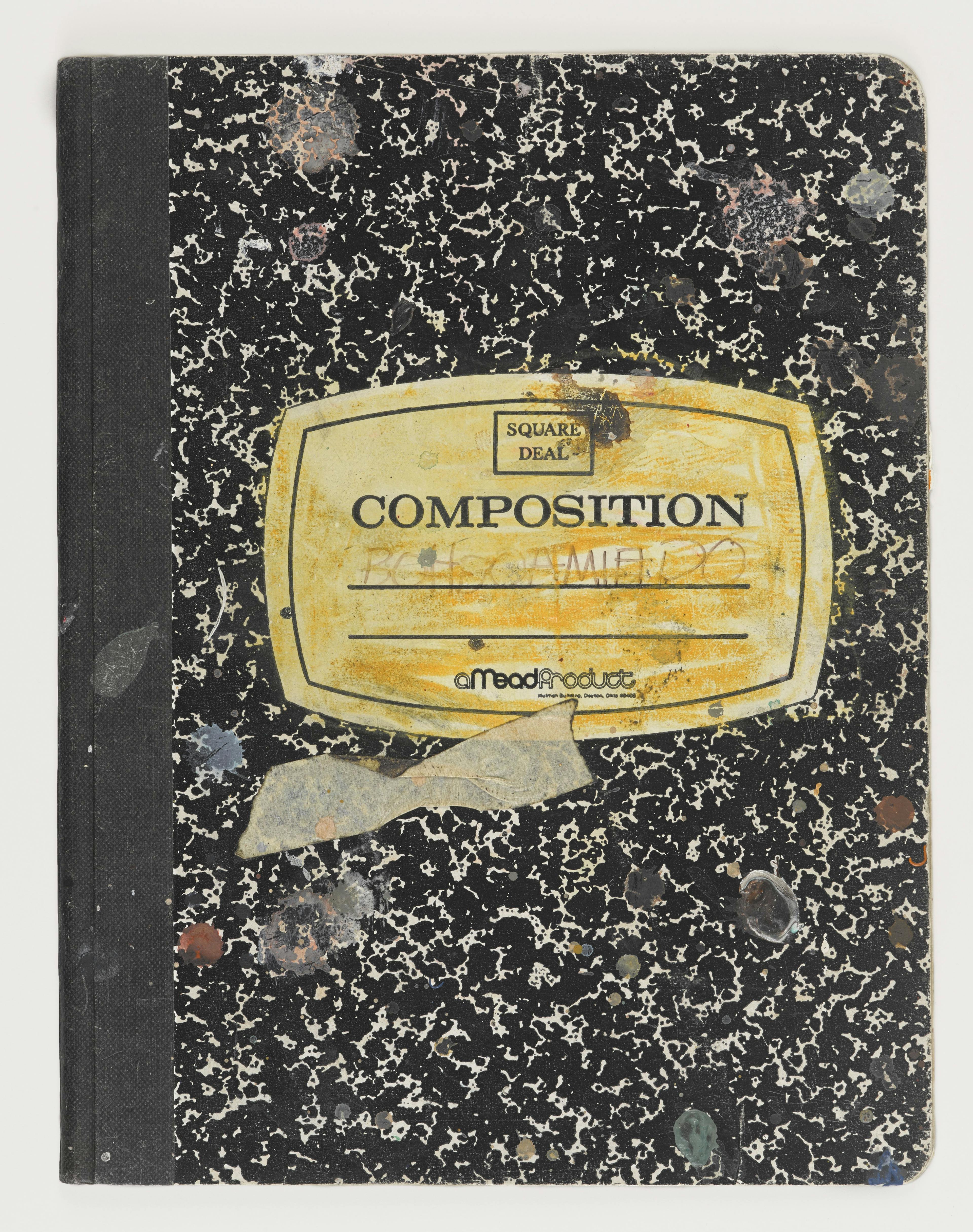 old school composition book defaced with scribbles and tape